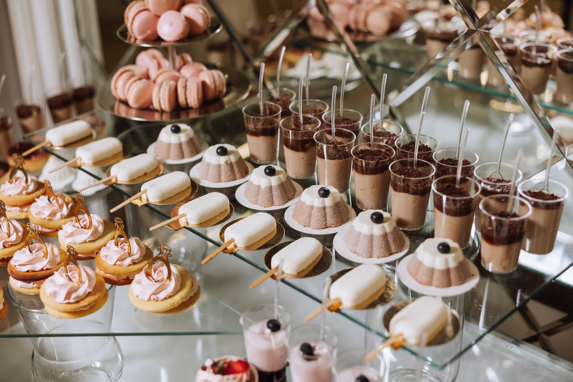 Almond cookies and various sweet cakes for a wedding banquet. A delicious reception, a luxurious ceremony. Table with sweets and desserts. Delicious colorful French desserts on a plate or table.